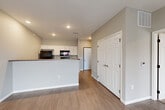 Located at 3500 S Grand Slam Ave in Sioux Falls, SD, this one-bedroom, one-bathroom unit offers a well-designed single-floor layout with a clean, modern aesthetic. Neutral gray tones and white trim carry throughout, creating a cohesive and contemporary feel.

The open-concept kitchen and living area form the heart of the unit. The kitchen features white shaker-style cabinetry, dark countertops, a peninsula with a raised breakfast bar, and black appliances including a refrigerator, range, microwave, and dishwasher. Wood-look flooring extends through the main living area, which receives natural light through a sliding glass door that opens to the exterior.

The bedroom is comfortably sized, finished with soft carpeting, and includes a window for natural light. A dedicated closet provides convenient storage. The full bathroom offers a single-sink vanity with light stone countertop, white cabinetry, and a full tub and shower combination, all finished with wood-look tile flooring.

A dedicated laundry area accommodates a full-size washer and dryer, adding everyday convenience. Recessed lighting in the kitchen and consistent neutral finishes throughout give the space a polished, move-in-ready appearance.