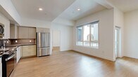 Located in the heart of Hollywood at 1233 N Highland Ave, this modern 2-bedroom, 1-bathroom residence offers a well-designed open-concept layout finished with light hardwood flooring throughout. The combined kitchen and living area forms the heart of the home, featuring a sleek kitchen equipped with stainless steel appliances — including a French door refrigerator, range, microwave, and dishwasher — complemented by light wood cabinetry, dark countertops, and a tile backsplash. The living area is bright and airy, benefiting from large windows that invite generous natural light and provide outdoor views. Both bedrooms are comfortably sized, each with windows and clean, neutral walls that create a calm, versatile atmosphere. The primary bedroom offers a notably generous footprint. The bathroom is well-appointed, featuring a tiled tub/shower combo, a wood-toned vanity with a dark countertop, and an illuminated mirror. A dedicated laundry area adds everyday convenience, while two closets provide ample storage. A private balcony extends the living space outdoors. The overall aesthetic is clean and contemporary, making this residence a polished urban retreat in one of Los Angeles' most vibrant neighborhoods.
