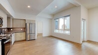 Located in the heart of Hollywood at 1233 N Highland Ave, this modern 2-bedroom, 1-bathroom residence offers a well-designed open-concept layout finished with light hardwood flooring throughout. The combined kitchen and living area forms the heart of the home, featuring a sleek kitchen equipped with stainless steel appliances — including a French door refrigerator, range, microwave, and dishwasher — complemented by light wood cabinetry, dark countertops, and a tile backsplash. The living area is bright and airy, benefiting from large windows that invite generous natural light and provide outdoor views. Both bedrooms are comfortably sized, each with windows and clean, neutral walls that create a calm, versatile atmosphere. The primary bedroom offers a notably generous footprint. The bathroom is well-appointed, featuring a tiled tub/shower combo, a wood-toned vanity with a dark countertop, and an illuminated mirror. A dedicated laundry area adds everyday convenience, while two closets provide ample storage. A private balcony extends the living space outdoors. The overall aesthetic is clean and contemporary, making this residence a polished urban retreat in one of Los Angeles' most vibrant neighborhoods.