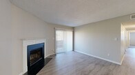 This thoughtfully designed single-floor residence in Memphis, Tennessee features 3 bedrooms and 3 bathrooms across a comfortable and functional layout. The living room serves as the heart of the home, showcasing light wood-look flooring, a classic white-mantled fireplace with a dark surround, and a sliding glass door fitted with vertical blinds that fills the space with natural light and provides access to an outdoor area. The kitchen is well-appointed with white shaker-style cabinetry, granite countertops, a stainless steel sink, a white subway tile backsplash, and black appliances, all complemented by matching wood-look flooring. The bedrooms are carpeted and offer a warm, comfortable atmosphere, with windows that bring in natural light. The primary bedroom is generously sized and includes ample closet space, featuring both a bifold closet and an additional open closet nook. The bathrooms are finished with granite countertops, white cabinetry, and large-format dark tile surrounding the tub-shower combinations. Throughout the home, textured ceilings, neutral wall tones, and clean white trim provide a cohesive and move-in-ready aesthetic. Additional features include a dedicated entrance, a hallway connecting the rooms, and two closets for storage.