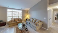 Located on Hermitage Hills Blvd in Hermitage, PA, this well-appointed single-floor home offers a thoughtfully designed layout with a cohesive neutral palette throughout. The kitchen is a standout feature, showcasing crisp white cabinetry, granite countertops, a large island with a built-in sink, and a full suite of stainless steel appliances, all complemented by light hardwood-style flooring and a ceiling fan overhead. Adjacent to the kitchen, the dining area features vaulted ceilings, elegant hardwood-style flooring, a decorative chandelier, and framed wall art, creating an inviting setting for meals. The living room offers generous natural light through oversized windows with views of the surrounding neighborhood and plush carpeting underfoot. The primary bedroom is spacious and comfortable, fitted with ceiling fan lighting and a window that brings in natural light. A second bedroom provides a cozy retreat with its own ceiling fan. A dedicated office or flex room features multiple windows and soft carpet, ideal for work or relaxation. The bathroom is finished with marble-style tile flooring, a white vanity, and a tub-shower combination. The attached two-car garage offers ample storage and parking space with an automatic opener system.