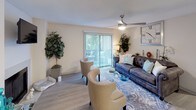Located at 3400 Sweetwater Rd in Lawrenceville, Georgia, this single-floor residence offers a thoughtfully designed layout with a warm, neutral aesthetic throughout. The living room serves as the heart of the home, highlighted by a clean white-surround fireplace with a wall-mounted television above it, light wood-style flooring, and a ceiling fan. A sliding glass door floods the space with natural light and opens to an outdoor area, creating a seamless indoor-outdoor connection. The living area is further elevated by its open feel and comfortable seating arrangement.

The galley-style kitchen is efficiently organized, featuring gray cabinetry, light countertops, a double-basin sink, and stainless steel appliances including a refrigerator and electric range. The space is well-lit and offers ample storage for everyday living.

The bedroom provides a tranquil retreat, with plush carpeting, a built-in window bench seat with blinds that invite soft natural light, and a textured ceiling. The room comfortably accommodates a large bed and complementary furnishings, offering a serene and restful atmosphere.

Throughout the residence, warm neutral tones, consistent flooring, and carefully selected finishes contribute to a cohesive and inviting living environment.