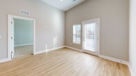 Located at 5808 Nall Ave in Mission, KS, this well-appointed one-bedroom, one-bathroom residence offers a thoughtfully designed single-level layout with modern finishes throughout. The open-concept living area seamlessly integrates the kitchen, dining, and living spaces beneath soaring ceilings, creating a bright and airy atmosphere enhanced by recessed lighting and light-toned walls. The kitchen is a standout feature, showcasing white shaker cabinetry, granite countertops, a subway tile backsplash, a peninsula with an undermount sink, and a full suite of stainless steel appliances including a refrigerator, electric range, built-in microwave, and dishwasher. Light wood-look flooring flows throughout the main living areas, complementing the clean, contemporary aesthetic. The living area benefits from an exterior door that invites natural light and outdoor access. The bedroom is a comfortable, carpeted retreat with ample natural light from a large window and access to a dedicated closet. The full bathroom features wood-look flooring, white cabinetry with granite countertops, a vanity with mirrors, and a tub-shower combination. A dedicated in-unit laundry room houses a full-size washer and dryer, adding everyday convenience. A utility room and additional storage complete this efficiently designed home.