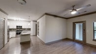 Located at 13220 Foster St in Overland Park, KS, this well-appointed 2-bedroom, 3-bathroom single-floor residence offers a thoughtfully designed layout with modern finishes throughout. The open-concept kitchen and living area serves as the heart of the home, featuring white shaker-style cabinetry, granite countertops, a subway tile backsplash, stainless steel appliances, and a central kitchen island with pendant lighting — ideal for both everyday living and entertaining. Built-in shelving adds a functional architectural detail to the living space.

Durable hardwood-style flooring runs throughout the home, complemented by warm crown molding and neutral-toned walls that create a clean, cohesive aesthetic. Ceiling fans are present in the main living areas and bedrooms, providing year-round comfort. The primary bedroom is a generously sized retreat with an en-suite bathroom featuring granite countertops, a walk-in shower, and access to a walk-in closet. The second bedroom includes a double-door closet and a bright window with outdoor views.

Additional highlights include three closets, an in-unit laundry area, and a pantry. With three full bathrooms, abundant storage, and a well-organized floor plan, this residence delivers a functional and attractive living environment in a desirable Overland Park location.