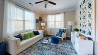 Located in Goose Creek, South Carolina, this single-floor residence offers a thoughtfully designed layout with a coastal-inspired aesthetic throughout. The open kitchen is a standout feature, showcasing gray shaker-style cabinetry, granite countertops, stainless steel appliances, and a central island with pendant lighting — ideal for both cooking and casual dining. Rich hardwood-style flooring runs through the main living areas, adding warmth and continuity to the space.

The living room is bright and welcoming, with multiple large windows that invite an abundance of natural light. Ceiling fans are featured in both the living room and bedrooms, enhancing comfort year-round. Crown molding in the living area adds a refined architectural touch.

Both bedrooms are carpeted for comfort and are well-proportioned, each featuring a ceiling fan, a window with natural light, and ample room for furnishings. The coastal decor theme carries throughout, creating a cohesive and relaxing atmosphere.

The bathroom is finished with granite countertops matching the kitchen, gray cabinetry, a undermount sink, and hardwood-style flooring, complemented by a shower-tub combination. Overall, this residence combines modern finishes with a serene, beach-inspired design sensibility.