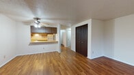 Located at 305 Nantucket Pl in Vermilion, Ohio, this single-floor residence offers a functional and comfortable layout. The spacious living area is finished with warm hardwood-style flooring and features a ceiling fan with light fixture overhead, along with a textured ceiling that adds subtle character. A convenient pass-through counter connects the living space to the kitchen, creating an open sightline between the two areas. The kitchen is well-appointed with ample dark wood cabinetry on both upper and lower levels, light-toned countertops, tile flooring, and white appliances including a range, dishwasher, and refrigerator. A window above the sink allows natural light to fill the kitchen. The unit includes two bedrooms, both carpeted for comfort and each with dark wood closet doors providing generous storage. The full bathroom is finished with tile flooring, a vanity with wood cabinetry, and a full tub and shower surround. Throughout the unit, clean white walls and consistent trim details create a neutral, move-in-ready aesthetic. Baseboard heating is present in several rooms, and multiple closets throughout the unit offer practical storage solutions for everyday living.