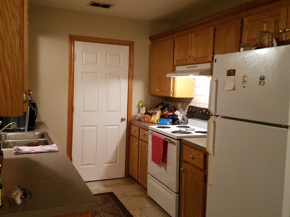 kitchen with laundry room beyond the door. - 5119 Galloping Way