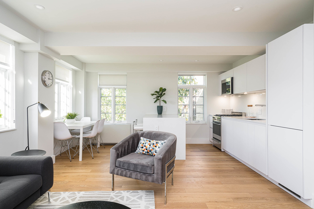 open concept living and dining room with hardwood floors - 2900 Adams Mill