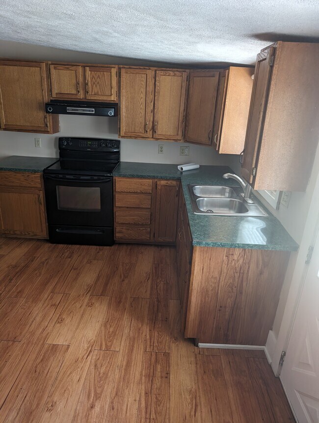 Full kitchen with stove, fridge and cabinet space - 244 N 10th St