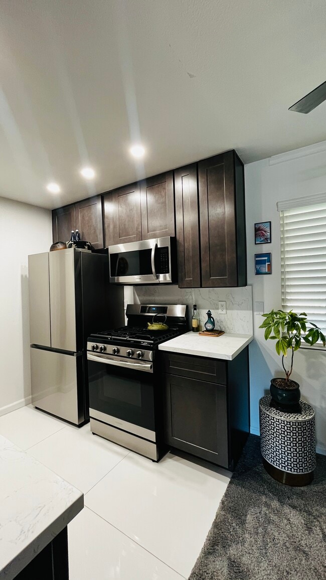 New kitchen with stainless steel refrigerator, dishwasher, stove with built-in air fryer, microwave - 6600 Warner Ave