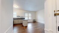 Located at 3030 N Sheridan Road in Chicago's sought-after Lakeview neighborhood, this single-floor unit blends classic architectural details with modern updates throughout. Rich, warm hardwood floors flow seamlessly across every room, complementing the crisp white walls and trim that give the space a clean, timeless aesthetic.

The kitchen is a standout feature, outfitted with white shaker-style cabinetry, dark countertops, a classic subway tile backsplash, and a full suite of stainless steel appliances including a gas range, microwave, and refrigerator. A peninsula provides additional counter space and creates a natural connection between the kitchen and the open living area. Large windows in the adjacent dining and living zone invite generous natural light and views of surrounding greenery.

The bedrooms are well-proportioned and bright, each featuring multiple windows fitted with blinds, hardwood flooring, and classic crown molding and baseboard details. Traditional cast-iron radiators add a charming period character consistent with the building's architectural heritage. The overall layout, as reflected in the dollhouse view, is thoughtfully organized with a logical flow between living, dining, kitchen, and bedroom spaces, making the unit both functional and inviting.