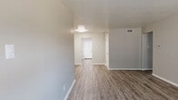 Located at 7913 Harwood Rd in North Richland Hills, TX, this single-floor, three-bedroom, one-bathroom unit offers a well-designed layout with consistent, modern finishes throughout. Wood-look luxury vinyl flooring flows seamlessly across every room, lending a cohesive and contemporary feel to the entire space.

The open living area is bright and welcoming, with neutral gray tones, clean white trim, and a window that brings in natural light. The galley-style kitchen is a standout feature, boasting crisp white shaker cabinetry, granite countertops, a mosaic tile backsplash, and a full suite of stainless steel appliances including a refrigerator, range, dishwasher, and microwave.

The spacious primary bedroom offers generous proportions, a ceiling fan with light fixture, a large closet, and a window with outdoor views. The two additional bedrooms are similarly finished, each equipped with ceiling fans and ample natural light. A central hallway connects the bedrooms and provides access to the full bathroom, which includes a shower/tub combo with clean white tile surround. Two closets offer convenient storage throughout the unit, completing this practical and attractively appointed home.