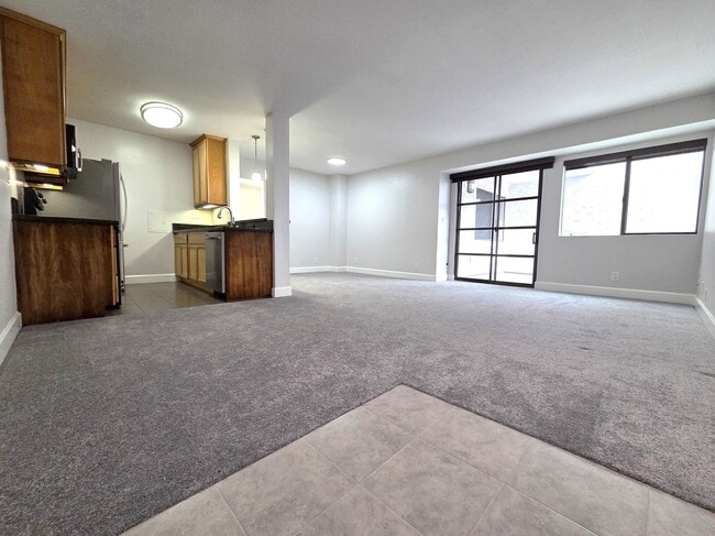 Living and dining area. Door to outside balcony. - 10982 Roebling Ave