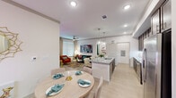 Located in Houston, TX, this well-appointed 2-bedroom, 2-bathroom single-floor residence offers a thoughtfully designed open-concept layout. The combined kitchen and living area serves as the heart of the home, featuring light wood-look flooring, recessed lighting, and large windows that invite abundant natural light. The kitchen is a standout, boasting rich dark-stained cabinetry reaching toward the ceiling, granite countertops, a large center island with an undermount sink, stainless steel appliances, and elegant pendant lighting. The living room is generously proportioned with a ceiling fan and direct access to the exterior. Both bedrooms are carpeted and equipped with ceiling fans, large windows with blinds, and closets. The primary bedroom includes access to a spacious walk-in closet lined with multi-level shelving and hanging rods. The primary bathroom features a dual-sink vanity with granite countertops, dark wood cabinetry, a soaking tub with tile surround, and tile flooring. A dedicated laundry room accommodates a full-size side-by-side washer and dryer. The layout also includes a hallway connecting the private quarters, creating a well-organized and functional floor plan throughout.