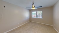 Located at 4179 Third Ave in San Diego's vibrant North Park/Hillcrest neighborhood, this single-floor unit offers a well-designed, open layout that maximizes functionality and comfort. The living area features warm hardwood-style flooring and neutral-toned walls, creating a bright and versatile space. Sliding glass doors lead to an outdoor balcony, allowing natural light to flow in and providing a connection to the surrounding environment. The open-concept kitchen is outfitted with white shaker-style cabinetry, granite countertops, a stainless steel undermount sink, and stainless steel appliances including a refrigerator and dishwasher, complemented by a peninsula that doubles as a breakfast bar. Recessed lighting illuminates the kitchen and adjacent living space efficiently. The bedroom is carpeted for comfort, features a ceiling fan with integrated light, and includes a window with blinds that offers views of the outdoors. The bathroom is finished with a clean, white tiled tub-and-shower combination with chrome fixtures. Throughout the unit, clean white trim and neutral paint tones contribute to a cohesive, modern aesthetic well-suited to San Diego living.