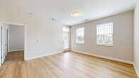 Located at 2150 Echo Dr in Sidney, OH, this well-designed one-bedroom, one-bathroom unit offers a bright and modern living experience across a single floor. Light-toned hardwood flooring flows throughout the main living areas, complemented by neutral beige walls and crisp white trim that create a clean, welcoming aesthetic.

The open-concept living, dining, and kitchen area is filled with natural light from multiple windows with blinds and a glass-panel entry door. The kitchen is a standout feature, boasting white shaker cabinetry with matte black hardware, granite countertops, a kitchen island with pendant lighting, and a full suite of stainless steel appliances including a range, microwave, dishwasher, and refrigerator.

The bedroom offers plush carpeting, a generous window with outdoor views, and access to multiple closets. The bathroom is finished with a granite-topped vanity, white cabinetry, and a walk-in glass-enclosed shower with built-in shelving and a chrome fixture.

Additional highlights include a private balcony, a dedicated laundry area, a utility room, and ample closet storage throughout. The unit presents a fresh, move-in-ready interior with modern finishes throughout.