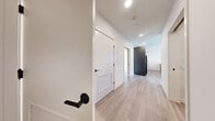 Located in Seattle's Queen Anne neighborhood, this well-appointed 2-bedroom, 2-bathroom residence offers a thoughtfully designed single-floor layout. Light-toned hardwood-style flooring flows consistently throughout, lending a clean, cohesive aesthetic to every room.

The open-concept kitchen and living area serves as the heart of the home. The kitchen features a large waterfall-edge island with an undermount sink and matte black fixtures, a subway tile backsplash, two-tone cabinetry in dark grey and warm wood tones, stainless appliances, and stylish globe pendant lighting. The adjacent living room is bathed in natural light from expansive floor-to-ceiling windows offering urban views of the surrounding Seattle streetscape.

The spacious primary bedroom receives generous sunlight and connects to a well-sized walk-in closet with built-in shelving and hanging rods. The second bedroom is bright and versatile, also with closet access. Both bathrooms are finished with white subway tile tub-shower surrounds, matte black hardware and fixtures, and light wood-style flooring, with the second bathroom featuring a large vanity mirror with integrated lighting.

Three closets provide ample storage throughout. The clean white walls, modern hardware, and consistent material palette give the entire residence a fresh, contemporary feel.