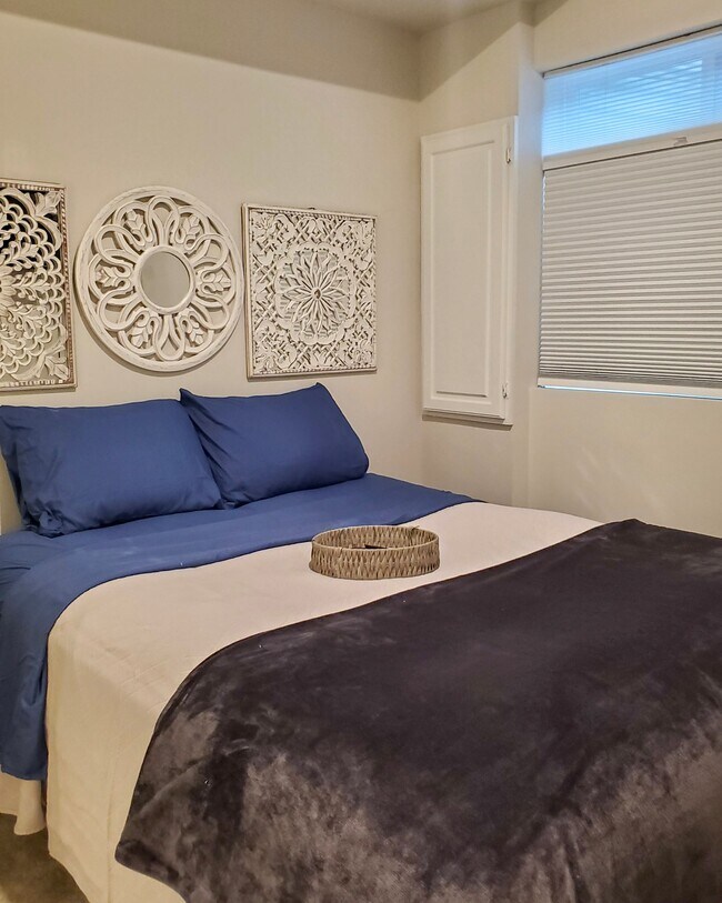The Drake Suite, fully furnished, flat screen TV, an entry closet, an ensuite bathroom with full closet, and private entrance/exit through the garage. - 1209 Trenton Pl SE