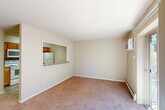 This one-bedroom, one-bathroom residence in Secane, PA offers a practical and comfortable single-floor layout. The living room is bright and open, featuring soft carpeting and sliding glass doors that lead to a private balcony, allowing natural light to flood the space and providing a pleasant outdoor view. Baseboard heating runs throughout the carpeted areas, ensuring year-round comfort.

The kitchen is efficiently designed with warm wood cabinetry, granite-style countertops, a tile backsplash, and white appliances including a refrigerator, electric range, and built-in microwave. Light wood-style vinyl flooring adds a clean, modern touch to the kitchen area, which connects to the living space via a pass-through window counter — ideal for casual dining or entertaining.

The bedroom is a comfortable, carpeted retreat with a window fitted with a wall air conditioning unit, allowing for independent climate control. Two closets provide ample storage throughout the unit.

The bathroom features classic white tile surrounding a full bathtub and shower combination, complemented by a white vanity with a large mirror and tile flooring. The neutral, light color palette throughout the entire residence creates a clean and inviting ambiance, making it a move-in ready home in a convenient Pennsylvania location.