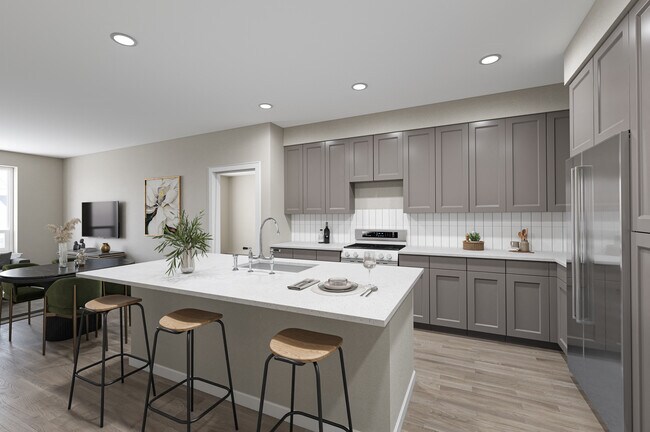 Modern Kitchen with Light Gray Cabinetry, White Quartz Countertops, and Island Bar Seating - Hensley at The District