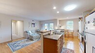 Located at 402 14th St NW, Unit 3B in Charlottesville, VA, this well-appointed residence offers three bedrooms, three bathrooms, and a thoughtfully designed single-floor layout. The open-concept kitchen features warm wood cabinetry, stainless steel appliances, and a peninsula with bar seating — ideal for casual dining or entertaining. Adjacent to the kitchen, the living room is bright and welcoming, with hardwood flooring, neutral walls, and glass doors that open onto a private balcony overlooking a lush, tree-lined setting. A dedicated dining area with a window view adds a functional and inviting space for meals. The spacious primary bedroom is filled with natural light from dual windows and features plush carpeting, providing a comfortable retreat. Additional bedrooms are well-sized with carpeted floors and direct bathroom access. All three bathrooms are practical and clean, featuring warm wood cabinetry, tiled flooring, and tub-shower combinations. A utility room rounds out the floor plan. Throughout the residence, a consistent palette of neutral tones, hardwood floors in common areas, and ample natural light create a cohesive and comfortable living environment.
