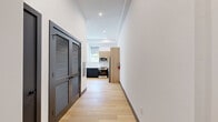 This well-appointed one-bedroom, one-bathroom residence at 188 Broadway in Woodcliff Lake, NJ offers a thoughtfully designed open-concept layout with modern finishes throughout. Light-toned hardwood flooring flows seamlessly across the entire living space, complemented by crisp white walls, dark baseboards, and gray interior doors that lend a clean, contemporary aesthetic.

The combined kitchen and living area serves as the heart of the home. The kitchen is outfitted with a large white quartz waterfall island with an undermount sink, warm wood cabinetry on both the upper and lower levels, a subway tile backsplash, stainless steel appliances including a full-size refrigerator, electric range, and built-in microwave, all illuminated by recessed ceiling lighting.

The bedroom is a comfortable, sun-drenched retreat featuring large windows with roller shades that offer views of the surrounding greenery. A dedicated closet provides ample storage.

The bathroom showcases a refined modern design with a wood-toned floating vanity, white quartz countertop, undermount sink, matte black fixtures and hardware, a large frameless sliding glass shower enclosure over a soaking tub, and large-format floor tiles. A dedicated closet rounds out the unit's storage. Natural light is a defining feature throughout, creating a bright and welcoming atmosphere.