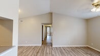 Located at 435 Kile Ln SW in Cleveland, Tennessee, this single-story, 3-bedroom, 2-bathroom home offers a well-organized layout designed for comfortable everyday living. The living room immediately impresses with its dramatic vaulted ceilings that lend a sense of openness and volume, complemented by light wood-style flooring that flows throughout the main living areas. A central hallway connects the bedrooms and bathrooms, providing a logical and efficient flow through the home. The galley-style kitchen features white cabinetry with ample storage, stainless steel appliances including a range and microwave, and a sink with countertop workspace — all set against the same light flooring for a clean, cohesive look. The three bedrooms each offer ceiling fans with light fixtures and windows with blinds that invite natural light and outdoor views. Two of the bedrooms feature soft carpeting, while others continue the wood-style flooring. The primary bedroom offers a comfortable, well-proportioned retreat. Both bathrooms are finished with light wood-style flooring, white vanities with storage, and brushed nickel hardware. One bathroom includes a full tub/shower combo. The neutral, warm color palette throughout creates a bright and inviting ambiance suited to a variety of lifestyles.