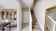Located at 4115 Britton Pky in Hilliard, Ohio, this multi-level home spans three floors and offers a functional, well-organized layout. The entry level welcomes visitors with tile flooring, a carpeted staircase with white railings, and a warm hallway that sets the tone for the rest of the home.

The main living level features warm hardwood flooring throughout, including a bright living area with a staircase, and a kitchen equipped with dark cabinetry, light countertops, black appliances, and direct access to an outdoor area via a glass-paned door. Natural light flows in through multiple windows, creating an inviting atmosphere.

The upper floor houses the two bedrooms, including a generously sized primary bedroom featuring plush carpeting, multiple windows with sheer curtains, and a serene, light-filled ambiance. The second bedroom is equally well-appointed. Three bathrooms serve the home across its floors — one features a tub-shower combo, while another includes a glass-enclosed shower, both finished with clean tile flooring and neutral tones.

A dedicated office space provides a quiet work area, complete with built-in cabinetry. Two closets and a hallway round out the layout, ensuring practical storage throughout. The home's neutral color palette and consistent design language create a cohesive, comfortable living environment.