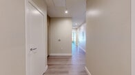 Located at 520 N Central Ave in Glendale, CA, this modern 2-bedroom, 3-bathroom residence offers a well-designed single-floor layout with contemporary finishes throughout. Light wood flooring flows seamlessly across the living spaces, complemented by warm neutral walls and recessed lighting that create a bright, welcoming ambiance.

The open kitchen is equipped with stainless steel appliances, sleek white cabinetry, and generous windows that allow natural light to pour in. The spacious living area is a standout, featuring dramatic floor-to-ceiling wraparound windows that frame sweeping views of the Glendale skyline and the San Gabriel Mountains beyond.

The primary bedroom is generously sized, boasting tall ceilings and direct access to a well-appointed en-suite bathroom. The bathrooms are finished to a high standard, with one featuring rich, dark marble-tiled walls, a glass-enclosed walk-in shower with a built-in bench, and modern fixtures. Additional bathrooms maintain a clean, minimalist aesthetic with neutral tile flooring and contemporary vanities.

A dedicated hallway connects the rooms efficiently, and a closet provides practical storage. The residence combines urban convenience with refined modern design, making it an exceptional living space in the heart of Glendale.