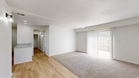 Located at 399 S Grant Ave in Columbus, Ohio, this one-bedroom, one-bathroom unit offers a thoughtfully designed single-floor layout. The open-concept living and kitchen area provides a seamless flow, with light hardwood flooring transitioning into plush carpet in the living space. A large sliding glass door with vertical blinds fills the living room with natural light and opens to an outdoor view, lending the space an airy, open feel.

The kitchen is a standout feature, boasting crisp white shaker cabinetry, granite countertops with a striking veined pattern, recessed lighting, and a breakfast bar peninsula. Black appliances, including a range and over-the-range microwave, provide a bold contrast to the clean white finishes.

The bedroom is a comfortable, well-proportioned room finished with soft carpeting, a window with blinds for natural light, and a sliding closet door offering convenient storage. Two hallways connect the rooms efficiently, contributing to a practical and organized layout.

The bathroom features a full tub-shower combination with a clean, neutral surround. Throughout the unit, the bright white walls and light color palette create a cohesive, modern aesthetic. The layout is efficient and well-suited for comfortable everyday living in the heart of Columbus.