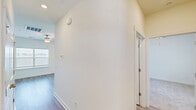 Located on Mulberry Blvd in Port Wentworth, GA, this single-story, one-bedroom, two-bathroom home offers a well-designed layout with quality finishes throughout. The kitchen serves as a central highlight, featuring a large island with a granite countertop and undermount sink, white shaker-style cabinetry, a subway tile backsplash, stainless steel appliances, and pendant lighting. Light wood-look flooring flows through the main living and kitchen areas, complemented by ceiling fans that enhance airflow and comfort. The bedroom is generously sized, finished with plush carpet, a ceiling fan, and a window overlooking the outdoors, while three closets provide ample storage — including a walk-in closet with wire shelving. The primary bathroom offers a granite-topped vanity, wood-look flooring, a walk-in glass shower, and a window for natural light. The second bathroom includes a full tub-shower combo, granite vanity, and consistent finishes. Connecting hallways keep the floor plan flowing efficiently. Clean white walls, bright natural light, and a cohesive color palette give the home a fresh, move-in-ready feel throughout.