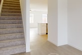 This modern two-story residence at 14206 Timber Fields Way, New Caney, TX 77357, offers 2000 square feet of living space. The home features four bedrooms, including a generous 200 square foot primary bedroom, and three bathrooms. The first floor spans 860 square feet, while the second floor provides 1140 square feet of space.

The interior boasts a clean, contemporary design with neutral tones throughout. Carpeted bedrooms offer comfort and warmth, while the kitchen and bathrooms feature durable wood-look flooring. The kitchen is equipped with white cabinetry, stainless steel appliances, and ample counter space, creating a functional cooking environment.

Bathrooms are outfitted with modern fixtures, including vanities with storage and large mirrors. The home's layout includes a living room, hallway, and two staircases for easy navigation between floors. Additional amenities include a laundry room and two closets for storage.

The property extends to the outdoors with a fenced backyard, providing privacy and space for outdoor activities. A garage offers convenient parking and additional storage options. The home's exterior features a brick facade, adding to its curb appeal and durability.

Overall, this residence combines functionality and modern design, making it an ideal family home in a suburban setting.
