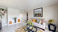 Located at 5500 El Camino del Rey St in Houston, TX, this single-story, 3-bedroom, 3-bathroom home offers a well-organized layout with thoughtful details throughout. The living room is a welcoming focal point, featuring a white-painted brick accent wall, light tile flooring, crown molding, and a large window that invites natural light. The adjoining dining room continues the bright, neutral palette with tile floors and a window overlooking the outdoors. The kitchen is equipped with dark cabinetry, ample counter space, and a dedicated pantry for additional storage. The primary bedroom is a comfortable retreat with a ceiling fan, tile flooring, and generous proportions. Two additional bedrooms, each with ceiling fans and tile floors, offer flexible use for guests or a home office. Three full bathrooms serve the home, and a hallway lined with louvered-door closets provides abundant storage. A dedicated laundry room with hookups adds everyday convenience. Four closets throughout the home ensure organized living. A patio extends the living space outdoors. The consistent light tile flooring and neutral wall tones create a cohesive, clean aesthetic throughout the entire home.