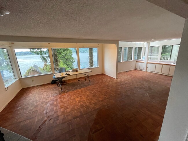 Large living room featuring fireplace, wetbar and panoramic lake views - 2591 Lake Whatcom Blvd