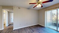 Located at 2880 North Wickham Road in Melbourne, Florida, this two-bedroom, three-bathroom single-floor unit offers a practical and comfortable layout. The open-concept living, dining, and kitchen area forms the heart of the home, finished with durable wood-look flooring that extends throughout the main spaces. The kitchen features dark espresso cabinetry, granite-style countertops, black appliances, a built-in range hood, and a pass-through breakfast bar that connects seamlessly to the living and dining areas. Each bedroom is carpeted for comfort and equipped with a ceiling fan with light fixture. The spacious primary bedroom includes an en-suite bathroom with a dark wood vanity, granite countertop, and mirror, while a second bathroom offers a full tub-shower combo with built-in shelving. A third bathroom adds further convenience. The unit includes three closets and a dedicated pantry for generous storage. An in-unit laundry area houses a full-size Whirlpool top-load washer and dryer. A private balcony provides outdoor access. Neutral tones, clean white trim, and consistent finishes throughout create a cohesive and move-in-ready living environment.