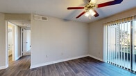 Located at 2880 North Wickham Road in Melbourne, Florida, this two-bedroom, three-bathroom single-floor unit offers a practical and comfortable layout. The open-concept living, dining, and kitchen area forms the heart of the home, finished with durable wood-look flooring that extends throughout the main spaces. The kitchen features dark espresso cabinetry, granite-style countertops, black appliances, a built-in range hood, and a pass-through breakfast bar that connects seamlessly to the living and dining areas. Each bedroom is carpeted for comfort and equipped with a ceiling fan with light fixture. The spacious primary bedroom includes an en-suite bathroom with a dark wood vanity, granite countertop, and mirror, while a second bathroom offers a full tub-shower combo with built-in shelving. A third bathroom adds further convenience. The unit includes three closets and a dedicated pantry for generous storage. An in-unit laundry area houses a full-size Whirlpool top-load washer and dryer. A private balcony provides outdoor access. Neutral tones, clean white trim, and consistent finishes throughout create a cohesive and move-in-ready living environment.