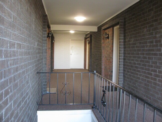 Second floor hallway. Condo entrance on left. - 10344 Forest Brook Ln