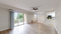 Located at 1022 Chesapeake Drive in Havre de Grace, Maryland, this two-bedroom, one-bathroom single-floor residence offers a well-organized and comfortable layout. The open-concept living room is a standout feature, showcasing light hardwood-style flooring, a ceiling fan, and large sliding glass doors that lead to a balcony overlooking lush greenery — flooding the space with natural light and offering pleasant outdoor views. The adjacent kitchen is thoughtfully designed with white cabinetry, a tile backsplash, light tile flooring, a skylight, and a full suite of stainless steel appliances including a gas range, microwave, dishwasher, and refrigerator. Both bedrooms are generously sized, featuring plush carpeting, ceiling fans, and ample natural light from windows with blinds. The primary bedroom includes a dedicated closet, while the second bedroom provides easy hallway access. The bathroom is finished with tile flooring and includes accessibility grab bars. A hallway connects the main areas efficiently, with a closet providing additional storage. The overall aesthetic is clean and bright, with a neutral color palette throughout that creates a calm, move-in-ready atmosphere.