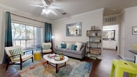Located in Austin, TX, this generously sized one-bedroom, one-bathroom residence offers a well-designed layout across a single floor. The open-concept living and kitchen area is anchored by rich hardwood-style flooring, crown molding, and a ceiling fan, creating a bright and welcoming atmosphere. Sliding glass doors lead to a private covered balcony overlooking mature trees, providing a peaceful outdoor retreat with wrought iron railing.

The kitchen is well-appointed with stainless steel appliances, including a refrigerator, range, and built-in microwave, complemented by white cabinetry, dark granite-style countertops, and a double-basin sink. The space flows seamlessly into the living area, making it ideal for both everyday living and entertaining.

The spacious bedroom features plush carpeting, a ceiling fan, and a large window that brings in natural light. The full bathroom includes a granite-topped vanity with white cabinetry, a large mirror, and a shower-tub combination. A dedicated closet provides ample storage, and a separate laundry area with a full-size washer and wire shelving adds everyday convenience. Crown molding throughout lends a refined, cohesive finish to the entire residence.