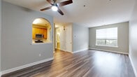 Located at 191 Horseshoe Ct in Phillipsburg, NJ, this well-appointed 1-bedroom, 2-bathroom unit offers a thoughtfully designed single-floor layout with a clean, neutral aesthetic throughout. The combined dining and living area is spacious and bright, featuring wood-style plank flooring, a ceiling fan with light fixture, and a large window that invites natural light and outdoor views. The kitchen is accessible via a charming arched pass-through and is equipped with warm honey-toned cabinetry, stainless steel appliances including a gas range, dishwasher, microwave, and refrigerator, complemented by light hardwood-style flooring. The bedroom offers comfortable carpeting, a window with outdoor views, and access to a dedicated closet with built-in shelving and drawers. Two bathrooms serve the unit: a full bathroom featuring a tiled tub-shower combo, vanity with storage, and tile flooring, and a half bathroom with a pedestal sink and tile flooring. Additional conveniences include two closets, two hallways, a dedicated laundry area, and a utility room. The unit's soft gray wall palette and consistent finishes create a cohesive and move-in-ready living environment.