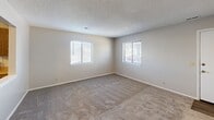 Located at 405 E Marion Rd in Wichita, KS, this two-story home offers three bedrooms and two bathrooms spread efficiently across two floors. The main level features an open living room with neutral carpet flooring and a staircase leading to the upper level, providing a welcoming central space. The kitchen is equipped with warm oak cabinetry, light countertops, wood-look vinyl flooring, and white appliances including a refrigerator, electric range, and dishwasher. A double sink and a window allow for natural light to brighten the workspace. A closet pantry adds convenient storage. Both bathrooms are clean and functional, with one featuring accessibility grab bars and wood-look flooring, and the other offering a shower-tub combo with oak cabinetry for storage. The three bedrooms are carpeted and neutrally painted, with the upper-level bedrooms benefiting from multiple windows that bring in natural light. The primary bedroom offers a comfortable footprint with two closets. A hallway connects the upper-level rooms. Textured ceilings are consistent throughout, and the overall palette of warm neutrals and natural wood tones creates a cohesive, practical living environment.