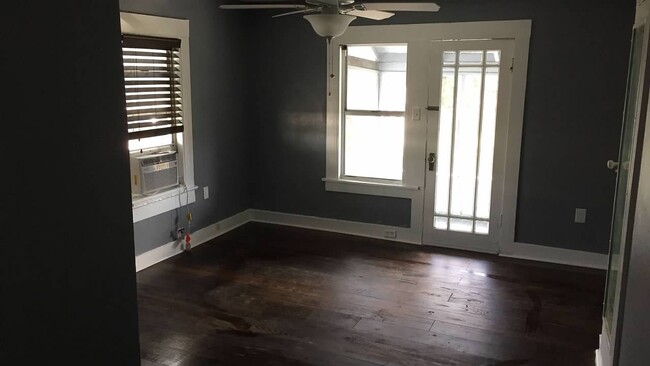 Living room with private balcony shown with not furniture. - 2212 N Massachusetts Ave