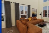 This two-story, 2-bedroom, 2-bathroom residence spans 1,900 square feet across two well-proportioned floors of 930 and 970 square feet respectively. The open-plan kitchen and living room anchor the main level, where soaring double-height ceilings and floor-to-ceiling windows flood the space with natural light and offer urban skyline views. Dark hardwood flooring runs throughout, complementing the warm, neutral wall tones. The kitchen features dark cabinetry with brushed hardware, white subway tile backsplash, quartz countertops, and stainless steel appliances including a gas range and side-by-side refrigerator. The living area comfortably accommodates generous seating and a dining area beneath the dramatic open upper volume. Both bathrooms are finished with white subway tile tub-shower combinations, rain showerheads, dark vanity cabinetry, and light tile flooring. The expansive 830 sq ft primary bedroom includes direct access to a dedicated walk-in closet outfitted with a full custom shelving and hanging system. The second bedroom offers urban views through large windows with recessed lighting overhead. Two hallways connect the floors, with a staircase visible from the living area, reinforcing the home's open, airy character throughout.