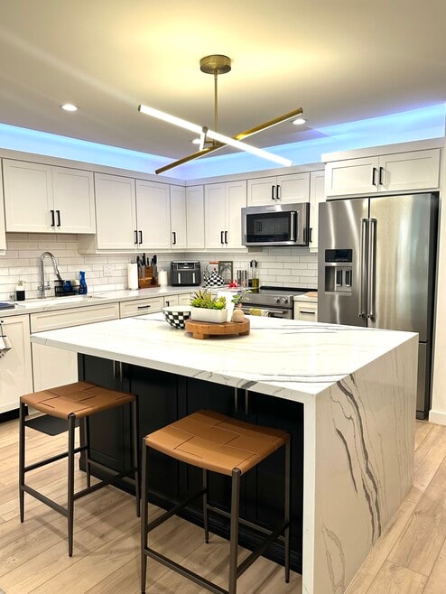 Kitchen with large island and waterfall countertop - 2318 Fox Hills Dr