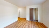 Located in the Kingfield neighborhood of Minneapolis, this single-floor unit at 3618 Colfax Ave S offers a straightforward and functional layout with notable vintage character throughout. The interior features warm hardwood flooring that extends through the main living area, complementing the white-painted concrete block walls that lend a clean, understated aesthetic to the space.

The living area is generously proportioned, bathed in natural light from multiple windows that look out toward the tree-lined street. A baseboard heating system runs along the perimeter walls, ensuring warmth during Minneapolis winters. A sliding-door closet provides practical built-in storage near the unit's entry.

The kitchen is compact and efficient, finished with a classic black-and-white checkered floor that adds a timeless retro charm. It includes white upper cabinetry, dark lower cabinets, a stainless steel sink with mosaic tile backsplash, and a gas range. A wall-mounted shelf adds additional storage utility.

The bathroom continues the vintage character with yellow ceramic tile wainscoting, penny-round tile flooring, and a pedestal-style sink — a cohesive nod to mid-century design. The overall ambiance of the unit is bright, clean, and practical, with classic details that distinguish it from more modern interiors.