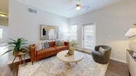 Located at 1150 Reid School Rd in Taylors, SC, this thoughtfully designed 2-bedroom, 2-bathroom residence offers a comfortable and modern living experience across a single floor. The open-concept layout seamlessly connects the living room, dining area, and kitchen, creating a cohesive and functional shared space. The living room features warm wood-look flooring, a ceiling fan, and a glass door that fills the room with natural light and provides outdoor access. The kitchen is outfitted with crisp white cabinetry, stainless steel appliances, a peninsula with bar seating, and pendant lighting — combining style with practicality. The adjacent dining area is highlighted by an elegant overhead chandelier and its own accent wall. Both bedrooms offer plush carpeting, ceiling fans, and calming sage green accent walls that lend a serene atmosphere. Natural light enters through window blinds, enhancing the airy feel of each room. Each of the two bathrooms features white vanity cabinetry, a tub-shower combination, and wood-look flooring, maintaining a consistent, clean aesthetic throughout. The residence includes a closet for added storage convenience, making this a well-rounded and inviting home.