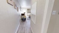 Located at 611 Lead Ave SW in Albuquerque, New Mexico, this well-appointed one-bedroom, one-bathroom unit offers a comfortable and functional single-floor layout. Light-toned wood-look flooring runs throughout the main living areas, anchoring a bright and cohesive aesthetic. The welcoming hallway leads into an open living room, where neutral walls and ample space create an inviting atmosphere. A dedicated dining area adjoins a galley-style kitchen outfitted with white shaker cabinetry, granite-look countertops, and stainless steel appliances, including a refrigerator and dishwasher. The bedroom is generously proportioned, featuring plush carpeting, a ceiling fan with light, and large windows with blinds that allow for abundant natural light. The full bathroom includes a tiled tub-and-shower combination. A dedicated in-unit laundry space accommodates a full-size washer and dryer, adding everyday convenience. The unit also includes a closet for additional storage. Throughout the space, clean lines, soft neutral tones, and thoughtful design choices contribute to a modern yet comfortable ambiance well-suited for Albuquerque living.