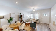 Located at 335 Marigold Drive in Myrtle Beach, SC, this single-story 2-bedroom, 2-bathroom home offers a thoughtfully designed layout with modern finishes throughout. The bright living room features wood-look plank flooring, a ceiling fan, and large windows that invite natural light, creating a welcoming and airy atmosphere. The kitchen is equipped with stainless steel appliances, gray shaker-style cabinetry, white countertops, and matching wood-look flooring, providing both style and functionality. Both bedrooms are carpeted and include ceiling fans and windows with outdoor views, offering a comfortable and restful setting. The primary bedroom features a spacious walk-in closet with wire shelving and ample storage capacity. The primary bathroom is elongated with a dual-sink vanity, white countertops, gray cabinetry, a walk-in shower, and wood-look flooring. The second bathroom includes a single vanity and a full tub-shower combination. A dedicated laundry room houses a full-size Samsung washer and dryer with overhead wire shelving. The home's neutral color palette and consistent finishes create a cohesive, move-in-ready feel throughout every room.