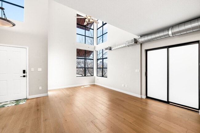 Building Photo - Modern 2BD, 1.5BA Condo with 20' Ceilings and Garage Parking Spot