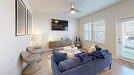 This contemporary 900 square foot apartment in Davenport, FL, offers a harmonious blend of style and functionality. The open-concept living area showcases a sleek living room with a comfortable gray sectional, modern artwork, and unique woven chairs, creating an inviting atmosphere. The kitchen boasts white cabinetry, stainless steel appliances, and granite countertops, perfect for culinary enthusiasts.

The apartment features two well-appointed bedrooms, including a spacious 160 square foot primary bedroom. Both bedrooms are adorned with plush carpeting, ample natural light from large windows, and tasteful decor. The primary bedroom includes a sizable dresser and round mirror, while the second bedroom showcases abstract art prints.

Two full bathrooms offer modern amenities, including tiled shower/tub combinations, granite countertops, and clean, white fixtures. The apartment's design emphasizes a cohesive color palette of whites, blues, and neutrals throughout, creating a calming and sophisticated ambiance.

Additional features include hardwood-style flooring in common areas, a ceiling fan for improved air circulation, and strategically placed lighting to enhance the overall atmosphere. With its thoughtful layout and high-end finishes, this apartment provides a comfortable and stylish living space in a desirable Florida location.
